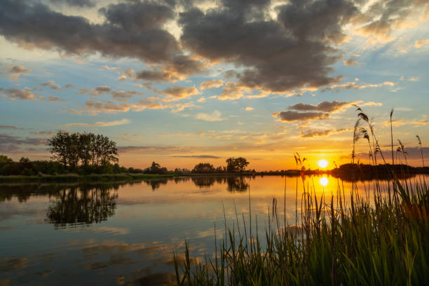 istock Beautiful sunset over a calm lake, summer day 1348876006