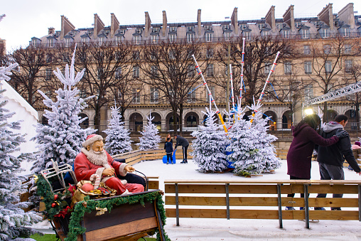Ice rink in Christmas market in Tuileries Gardens, Paris, France