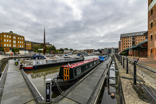 Traditional narrow boat barges in Gloucester Docks with warehouses