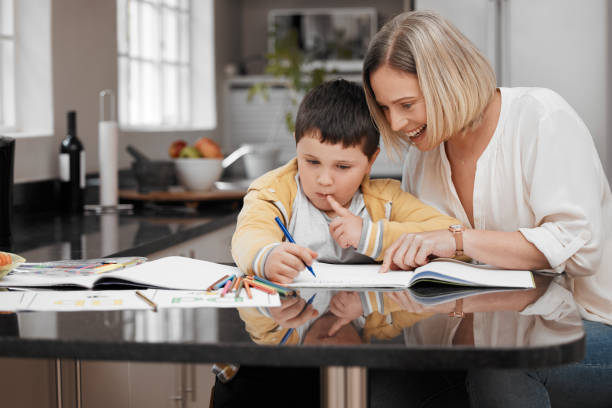 istock Shot of a beautiful mother helping her son with his homework 1348882811