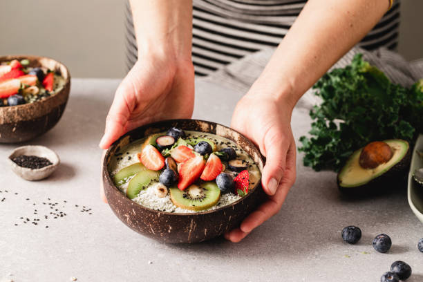istock Woman making healthy smoothie bowl 1348884375