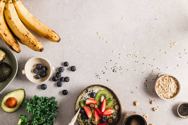 Healthy smoothie bowl with ingredients on kitchen counter