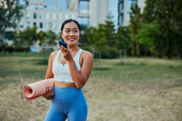 istock Sportswoman in the park texting on smartphone 1348886563