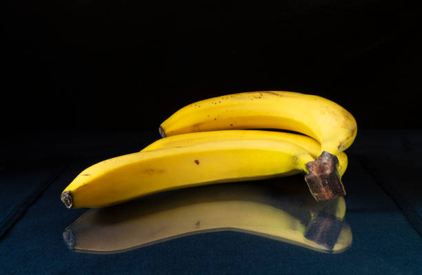 istock The Ripe bananas to rest upon table with reflection 1348886723