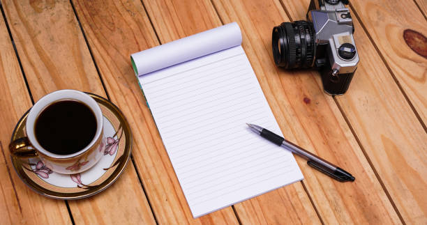 istock blank white paper notes with coffee and old camera on top wood table 1348886756