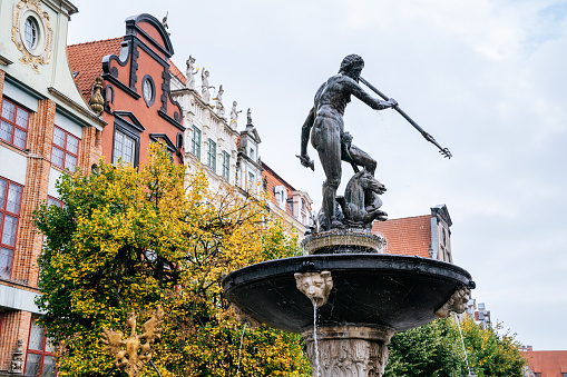 Old city of Gdansk. Neptune Fountain, a bronze statue of the sea god erected in 1549 and converted to a fountain in 1633 and restored in 2011/12.