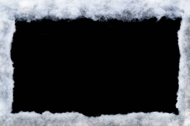 istock Winter frame made by snow isolated on black background 1348893204