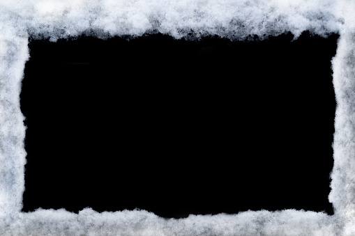 Winter frame made by snow isolated on black background