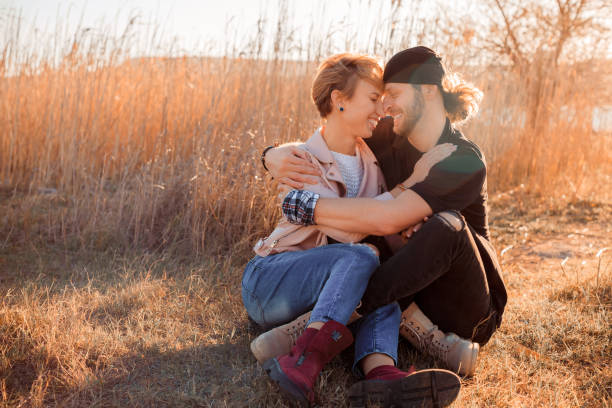 istock happy couple by the lake at sunset 1348906566