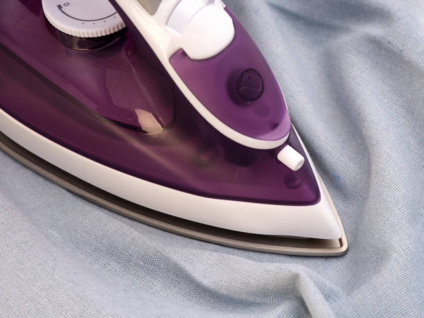istock A violet iron ironing blue linen textile 1348916015