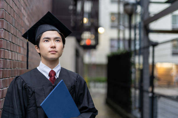Portrait of male student on graduation day from university stock photo