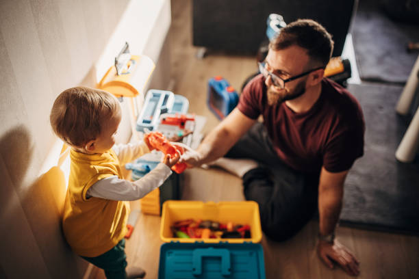 istock Father and little son playing at home 1348925122