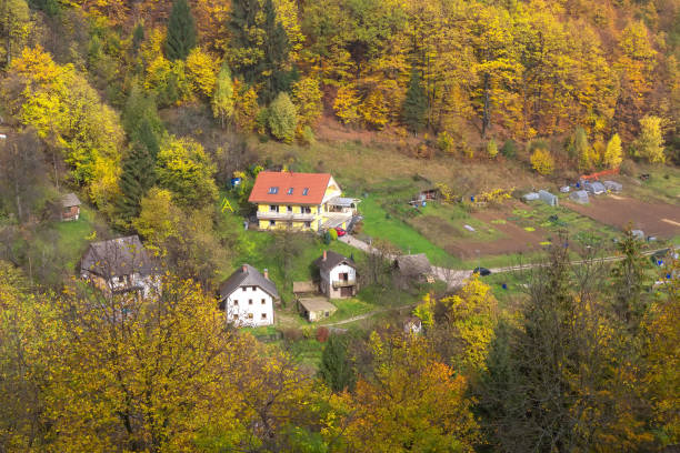 istock Mountain village, autumn forest trees, Slovenia 1348926259