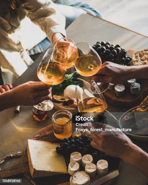 Hands Of People Clinking Glasses With Orange Or Rose Wine Stock Photo - Download Image Now