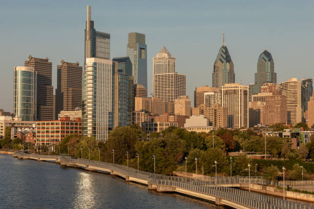istock Philadelphia Downtown skyline with the Schuylkill river. Beautiful Sunset Light. Schuylkill River Trail in Background. City skyline glows under the beautiful sunset light 1348929696