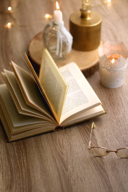 istock Book, Reading Glasses and Candles 1348931629