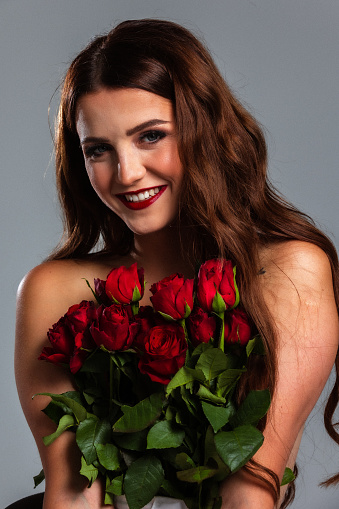 Beautiful woman covered with tulips , studio shoot, romantic