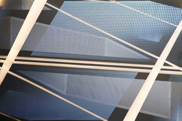 istock Computer graphic image of office building framework fragment and decorative perforated wall panel. Grid structures seen through each other. Architectural surfaces. Metal in modern architecture. 1348932516