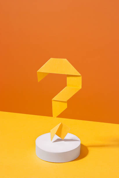istock Artistic yellow and orange background with origami question mark 1348933049