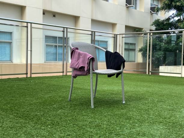 istock A gray plastic chair with a shirt hanging on it. 1348934263