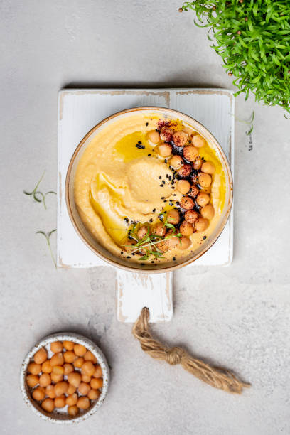 Traditional homemade chickpea hummus with olive oil Traditional homemade chickpea hummus with olive oil and spices lebanese culture stock pictures, royalty-free photos & images