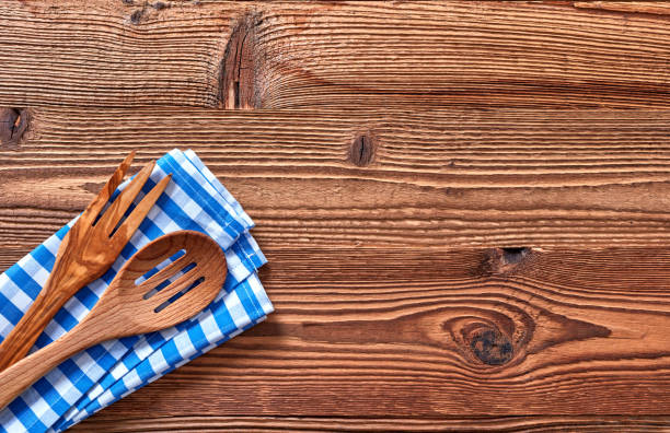istock Top view of wooden fork and spoon on kitchen towel 1348937805