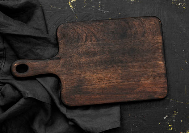 istock Empty vintage wooden cutting board on wooden table 1348937819