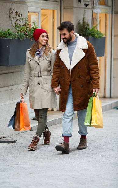 istock Couple walking down the street, holding hands. 1348938340