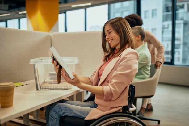 istock Smiling woman holding photo frame at work 1348940290