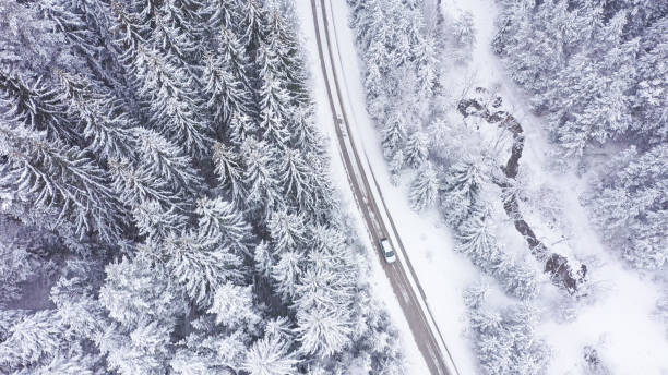istock Car driving on winter country road 1348940358