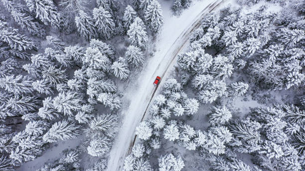 istock Car driving on winter country road 1348940415