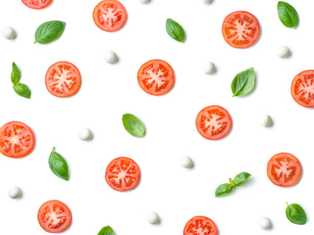 Pattern of fresh tomato slices, basil leaves and mozzarella cheese balls Pattern of fresh tomato slices, basil leaves and mozzarella cheese balls isolated on white background, top view, flat lay mozzarella photos stock pictures, royalty-free photos & images