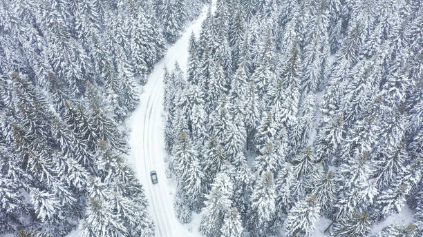 istock Car driving on winter country road 1348940514