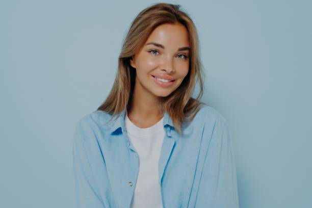 istock Gorgeous woman with clean skin posing on light blue background 1348941810