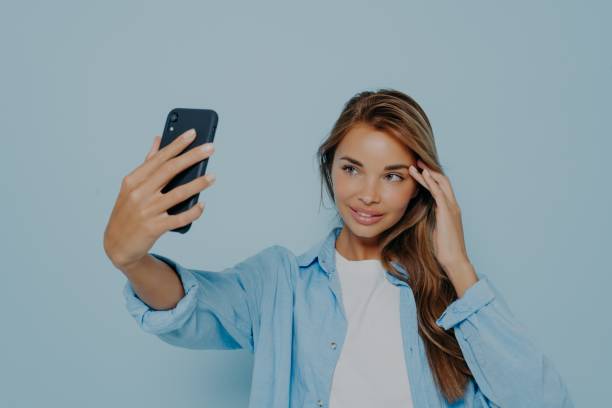 istock Gorgeous model making selfie on mobile phone 1348941828