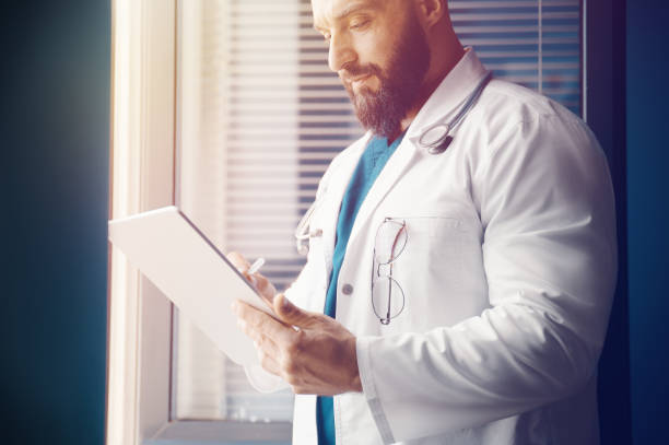 istock Doctor examines information and writes a prescription online with modern technology 1348941885