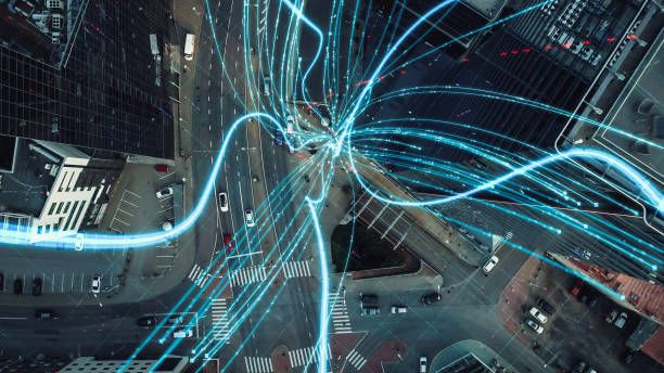 istock VFX and E-Commerce Visualization of Information Lines Flying from Tablet into Global Digital Network. Top Down Aerial Drone Shot in Business Downtown District. 1348942302