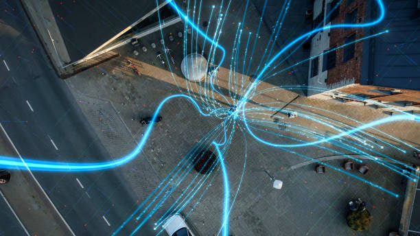 istock VFX and E-Commerce Visualization of Information Lines Flying from Mobile Phone into Global Digital Network.  Top Down Aerial Drone Shot in Business Downtown District. 1348942304