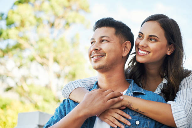 istock Cropped shot of an affectionate young couple looking thoughtful while chilling outside on their patio in the yard 1348944483