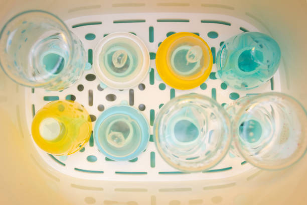istock Overview inside a baby bottle sterilizer in which there are bottles and tetines to sterilized. Steam sterilizer for sterilize baby milk bottle accessories 1348947585