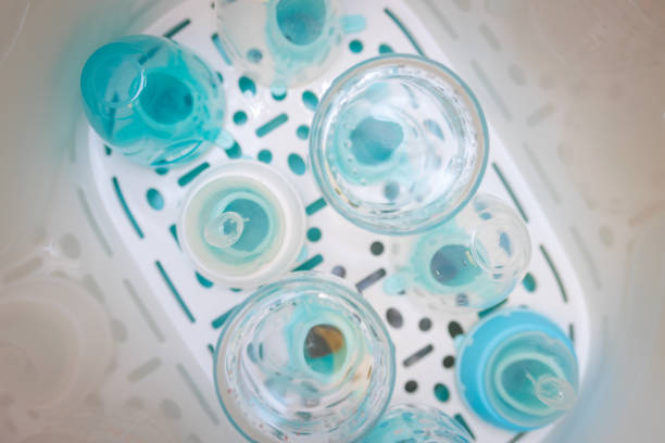 Overview inside a baby bottle sterilizer in which there are bottles and tetines to sterilized. Steam sterilizer for sterilize baby milk bottle accessories