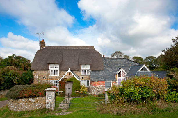 Poel, Mecklenburg, Germany - july 16, 2020: a typical northern thatched house with roses in Schwarzer Busch
