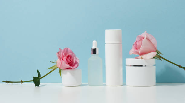 istock jar, bottle and empty white plastic tubes for cosmetics on a white table. Packaging for cream, gel, serum, advertising and product promotion, mock up 1348947803