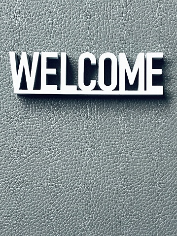 White welcome sign on gray background