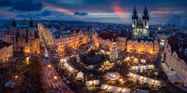 Panoramic view to the old town square of Prague with the famous Christmas Market Panoramic view to the old town square of Prague with the famous Christmas Market and festive lights during a cold winter evening prague christmas market stock pictures, royalty-free photos & images