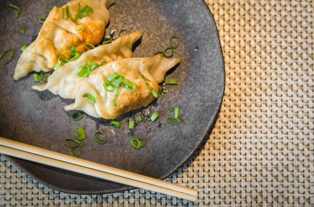 istock Gyoza or dumplings snack with soy sauce, selective focus, copy space. 1348953795