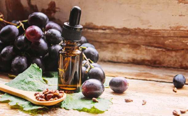 istock Extract of grape oil in a small jar. Selective focus. food 1348954336