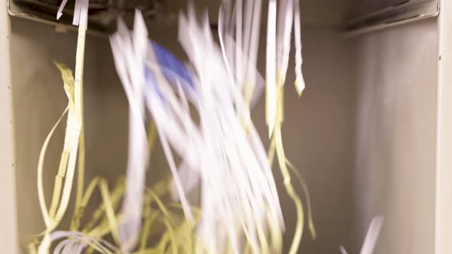 Detail of a paper shredder machine. Shredding paper