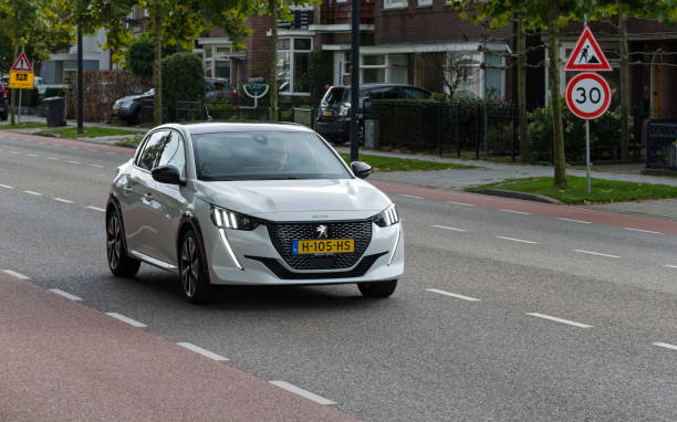 Dutch white 2020 Peugeot 208 driving in Enschede stock photo