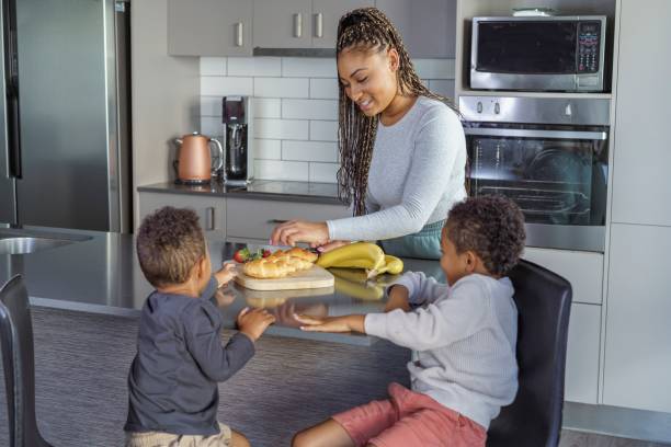 istock Mother preparing breakfast for her children 1348966623